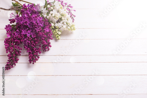 Lilac flowers on wooden background.