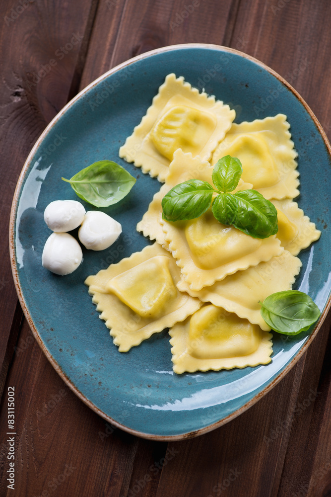 Ravioli with mozzarella stuffing and green basil, close-up Ravioli with mozzarella stuffing and green basil, close-up