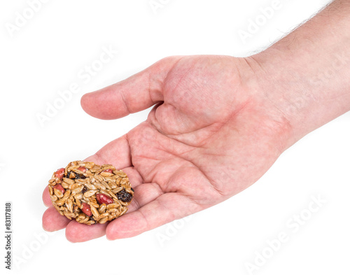 Candied roasted peanuts seeds in hand.