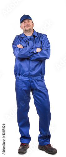 Man in working clothes crossed arms.