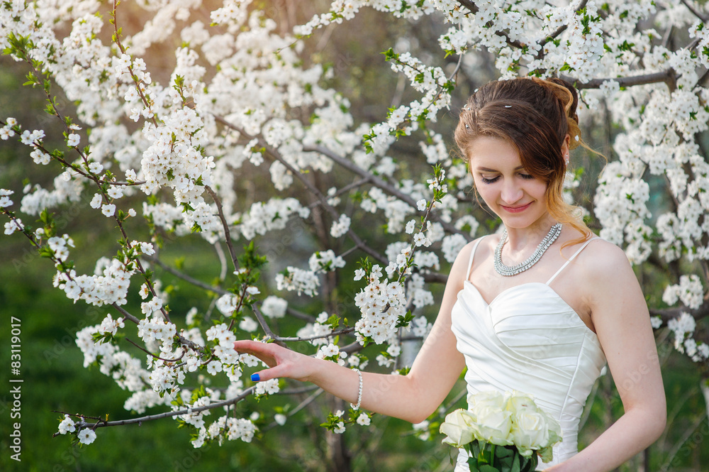 Beautiful bride in a blossoming spring garden Beautiful bride in a blossoming spring garden