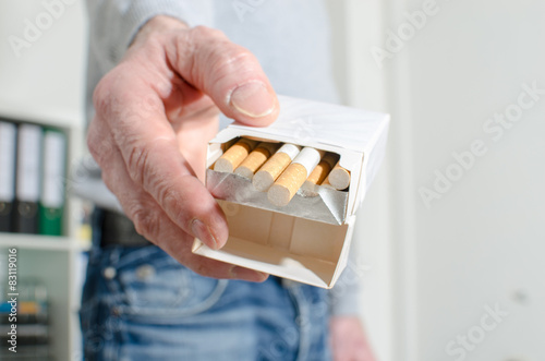 Man hand offering cigarettes
