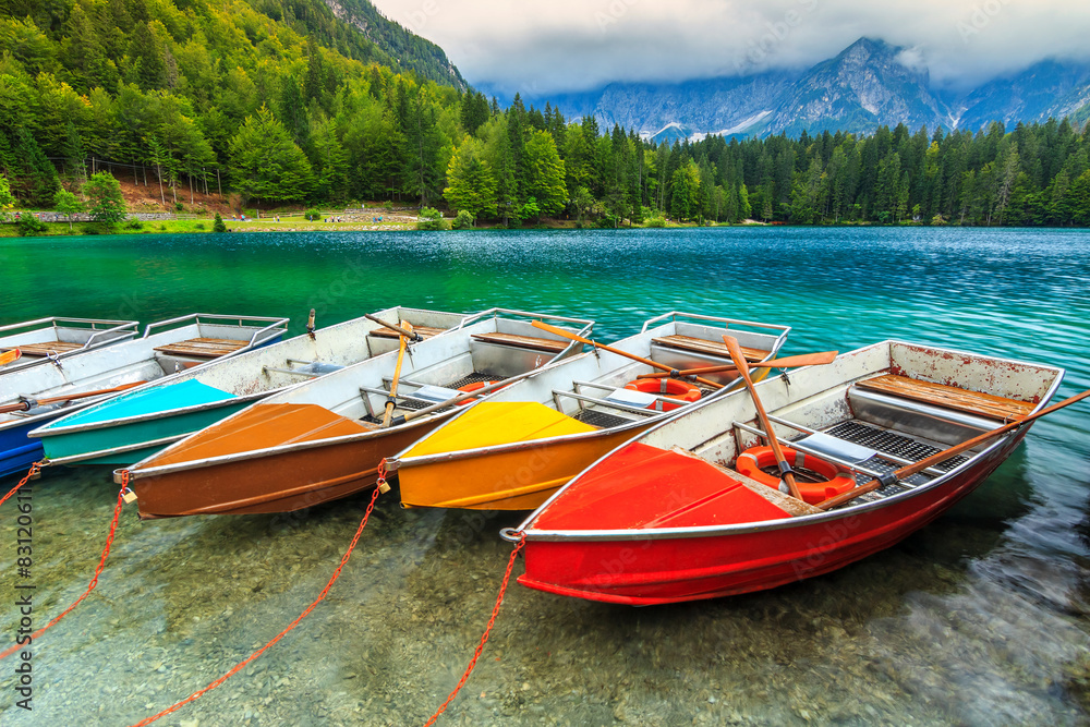 Stunning alpine landscape and colorful boats,Lake Fusine,Italy