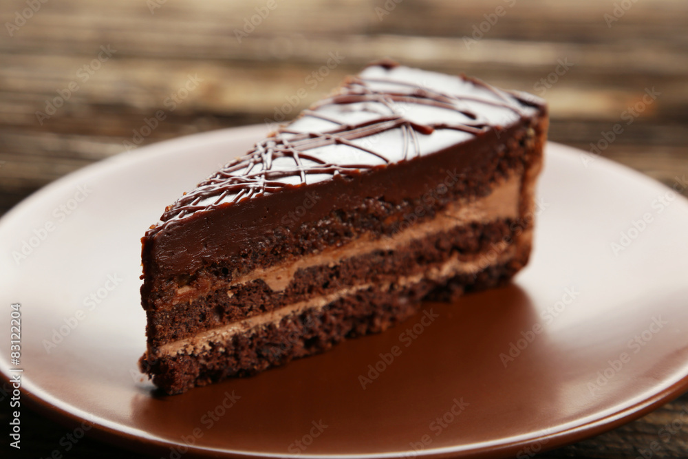 Dark chocolate cake on brown wooden background Dark chocolate cake on brown wooden background