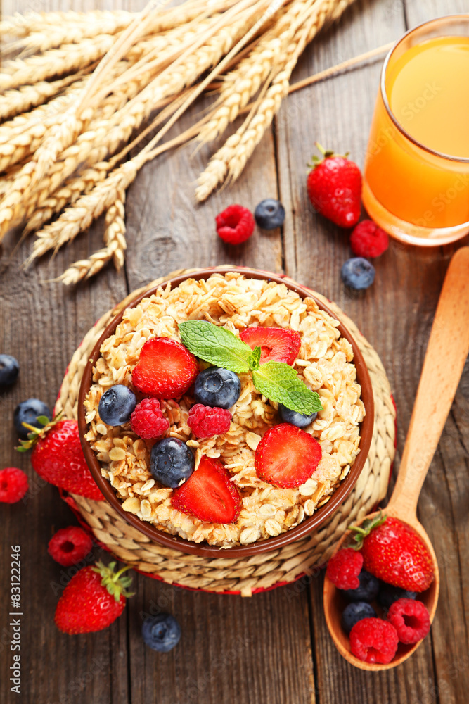 Oatmeal with berries on brown wooden background Oatmeal with berries on brown wooden background