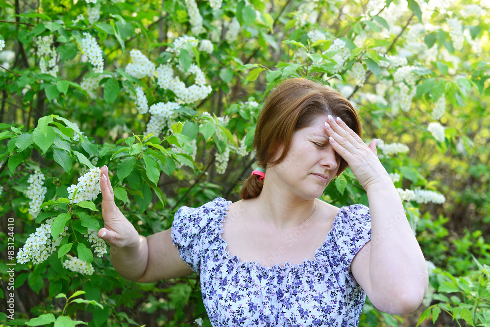 adult woman with headache about bird cherry blossoms in spring adult woman with headache about bird cherry blossoms in spring