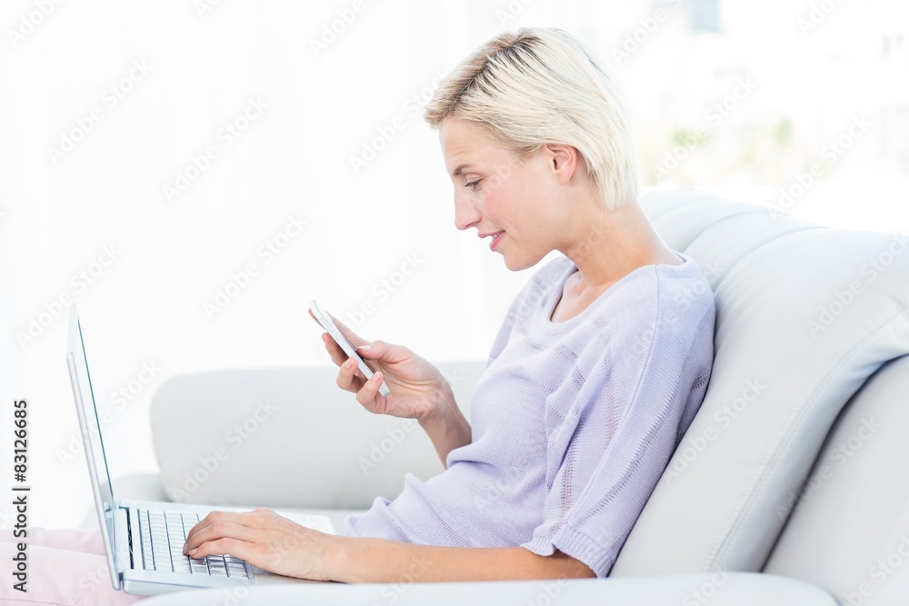 Pretty blonde woman texting with her mobile phone Pretty blonde woman texting with her mobile phone