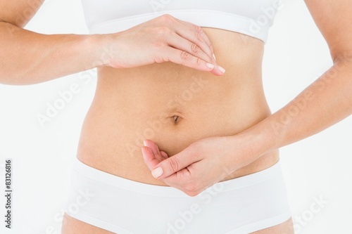 Fit woman with hands on her stomach 
