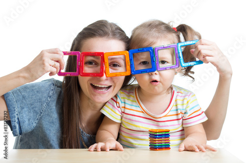 child and mother playing with magnetic constructor toy