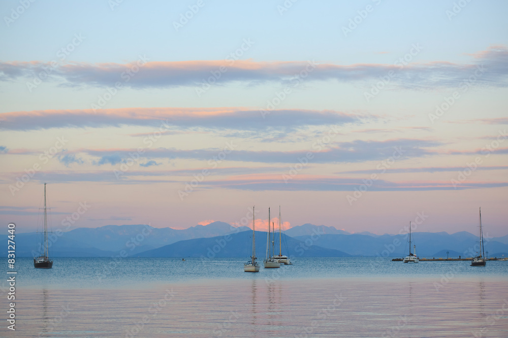 Sailing boats in the sea at sunset in Corfu's harbor