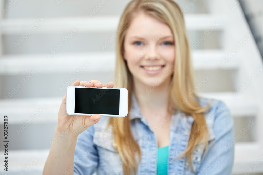 close up of happy teenage girl showing smartphone