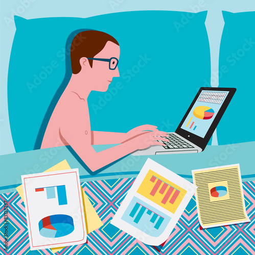 Man in bed working on the laptop