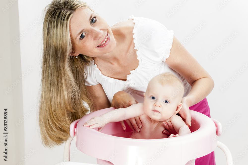 portrait of mother with her baby during bathing