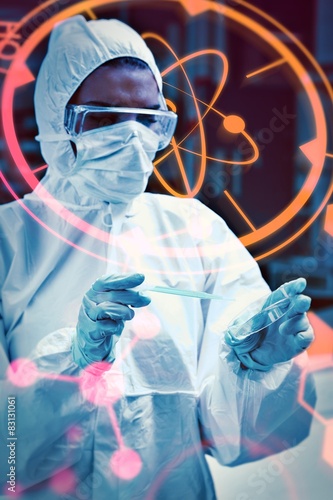 Protected scientist dropping dangerous liquid in a petri dish photo