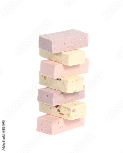 Vertical tower of different pastilles on white background photo