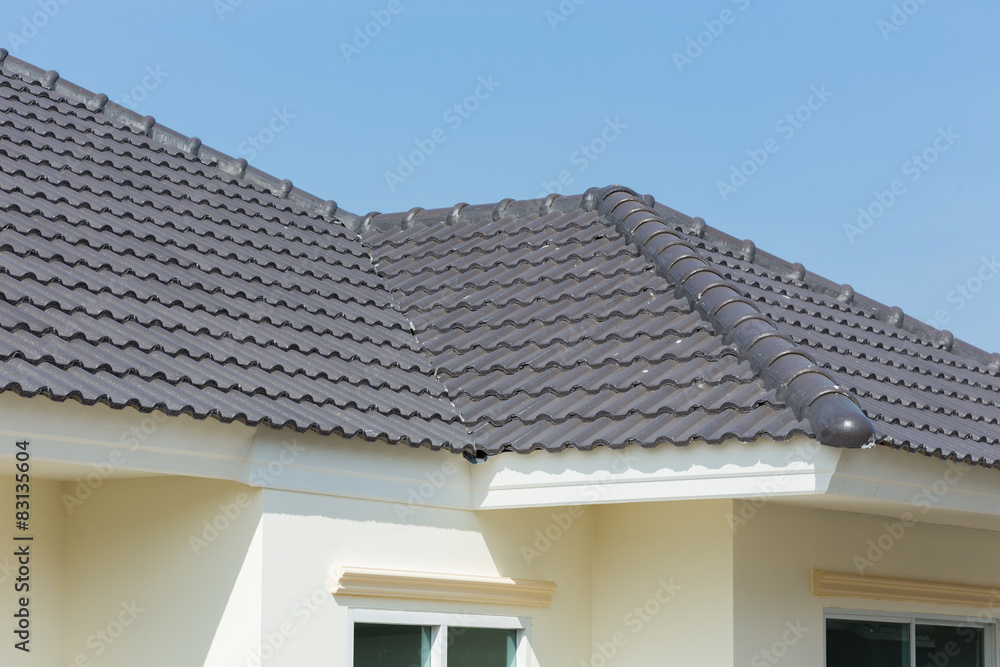 black roof tiles on house with blue sky - obrazy, fototapety, plakaty 