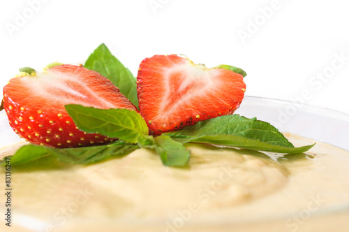 Custard dessert with fresh strawberry and mint
