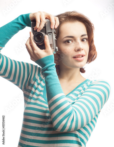 Attractive brunette aims her camera, isolated on white