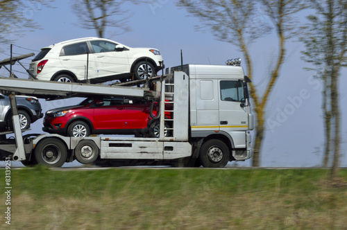 tow truck transports new cars for sale