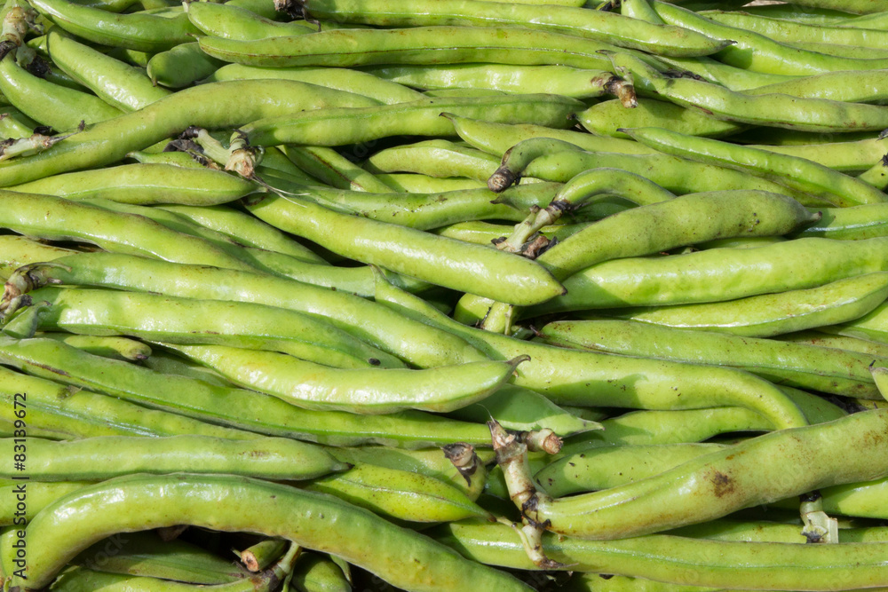 small and slender green beans (haricot vert) on a wood