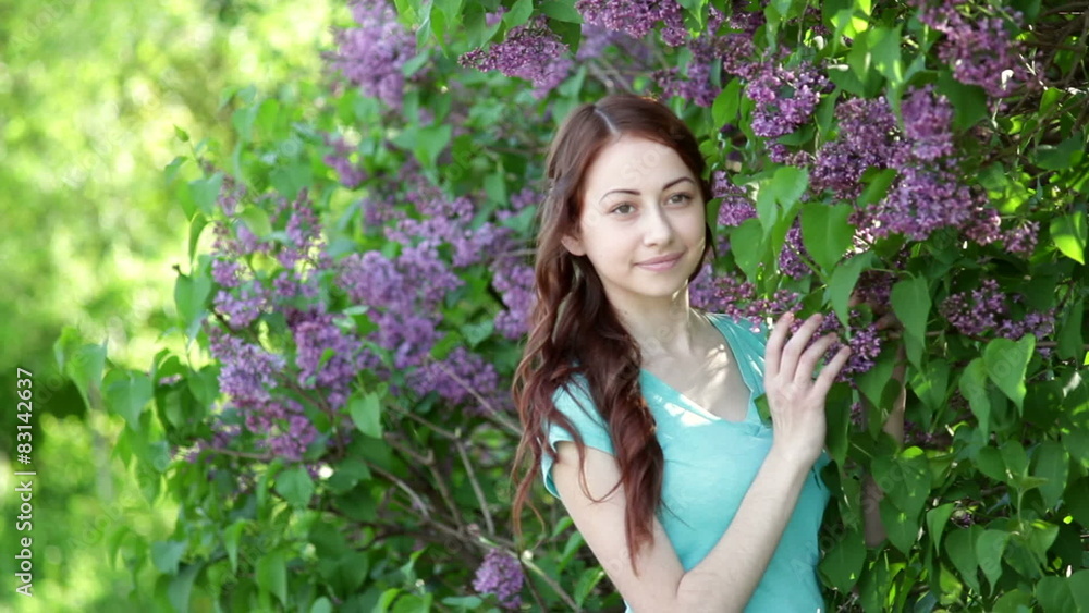 young women walking outside in a park lilac tree young women walking outside in a park lilac tree