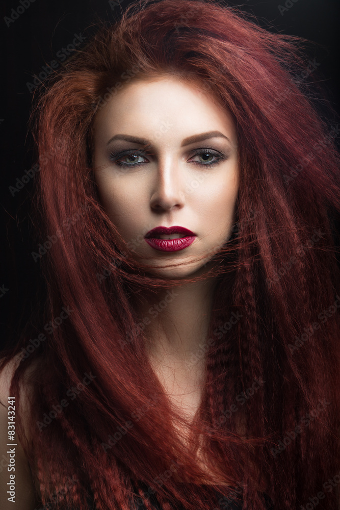 Fototapeta premium girl with bright makeup with the wind in hair.