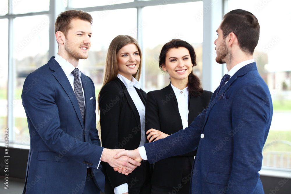 Business people shaking hands, finishing up a meeting Business people shaking hands, finishing up a meeting