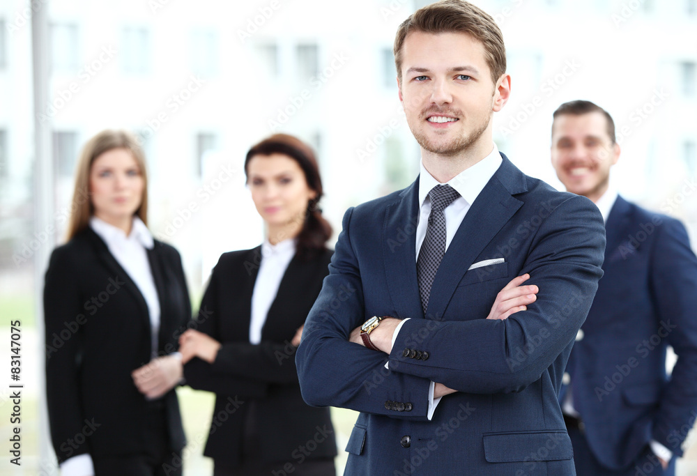 Businessman with colleagues in the background Businessman with colleagues in the background
