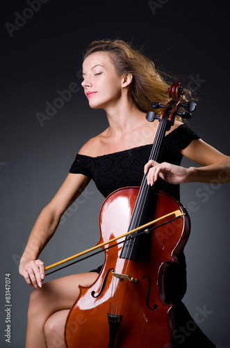 Female musical player against dark background