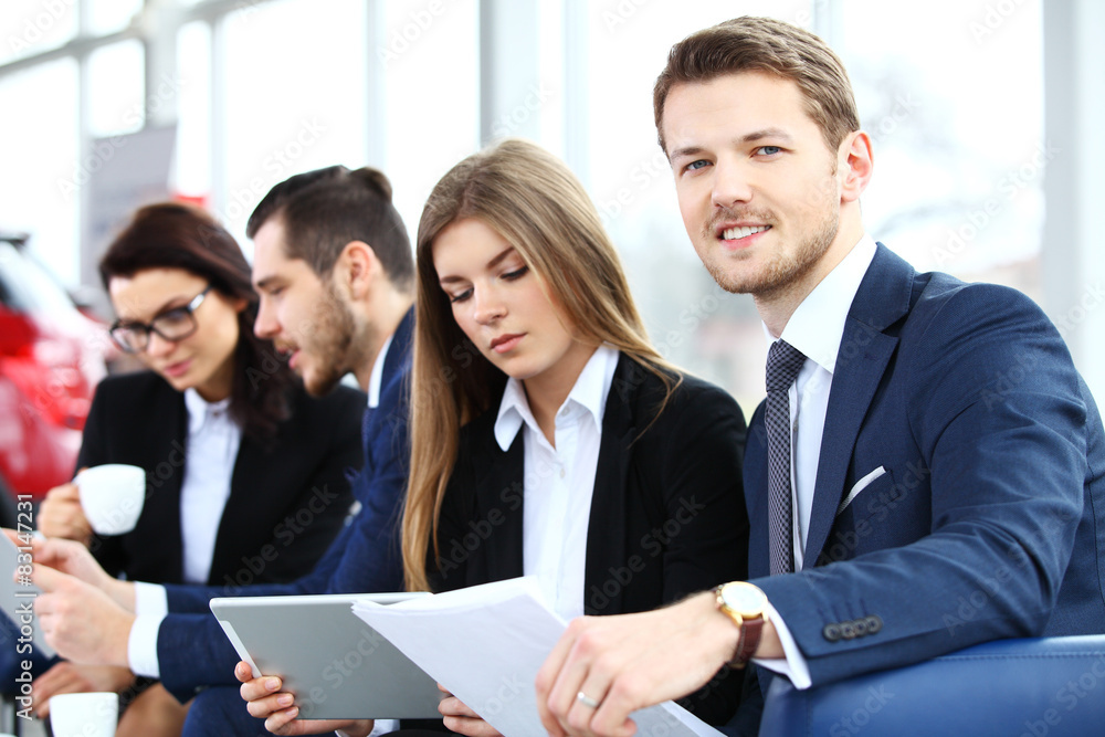 Image of business partners discussing documents and ideas Image of business partners discussing documents and ideas