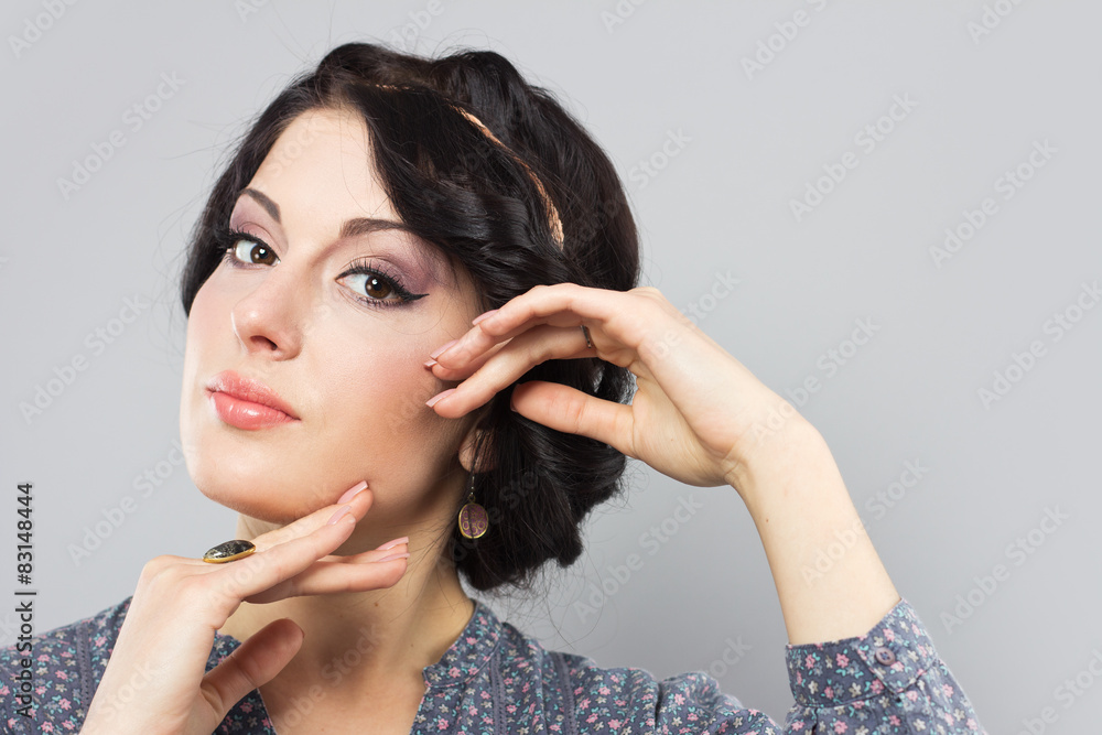 Beautiful brunette on a gray background Beautiful brunette on a gray background