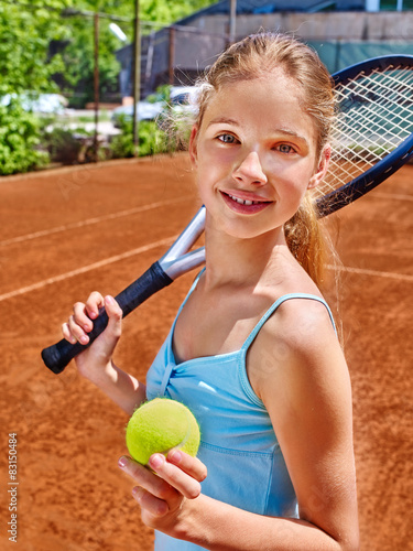 Girl athlete  with racket and ball on  tennis court photo