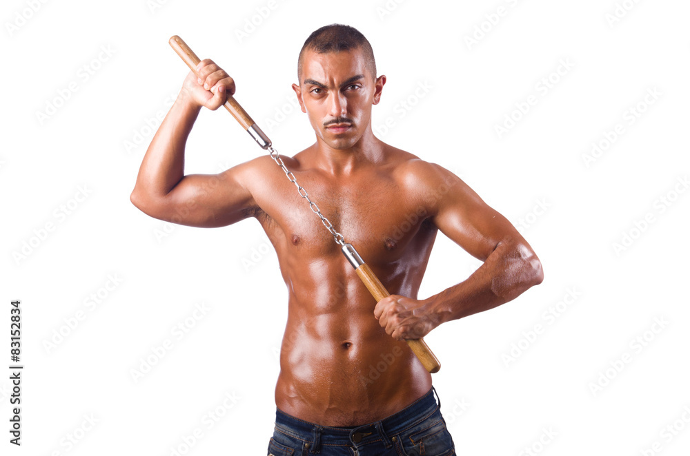 Young man with nunchucks isolated on white Young man with nunchucks isolated on white
