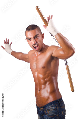 Young man with nunchucks isolated on white