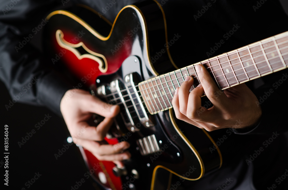 Fototapeta premium Man with guitar during concert