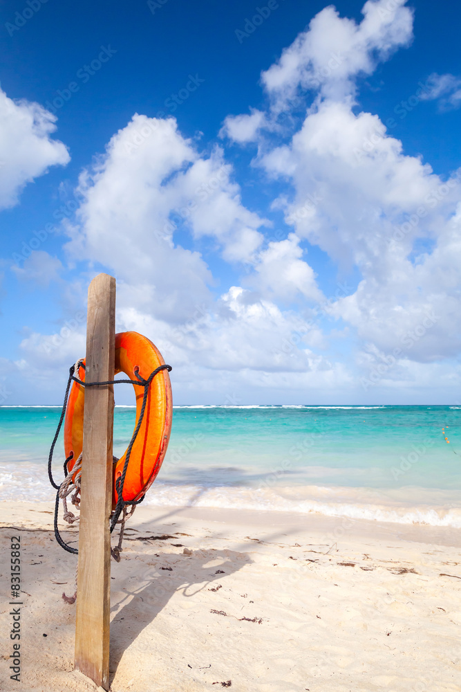 Obraz premium Red life buoy hanging on wooden pole