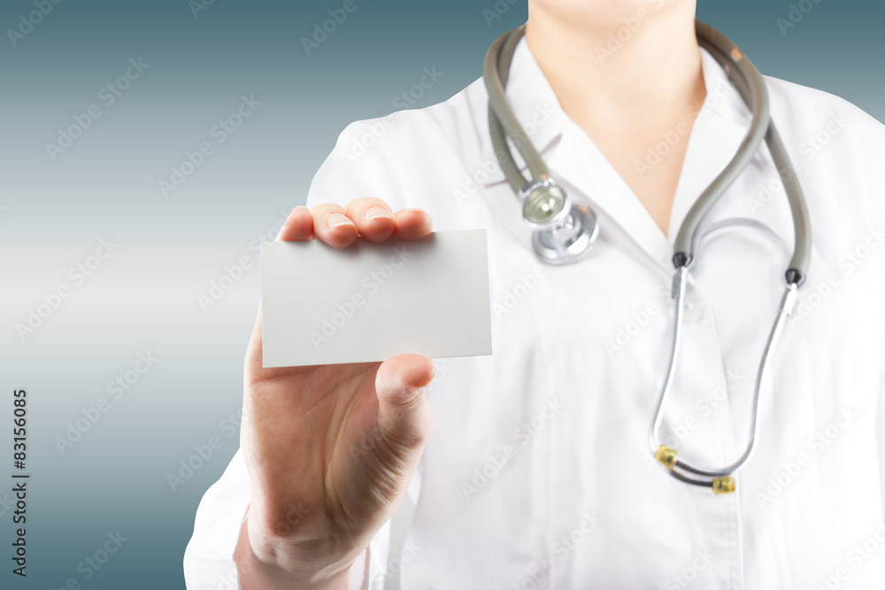 Female doctor's hand holding blank business card. Close up shot Female doctor's hand holding blank business card. Close up shot