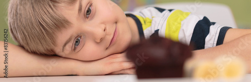 Cute boy and chocolate cupcake