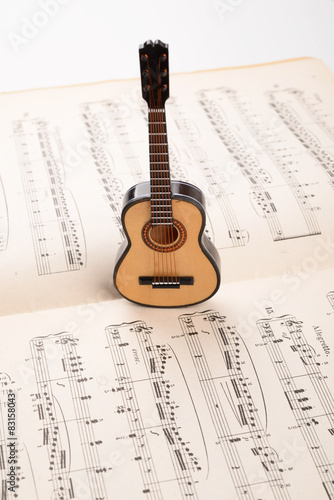 SMALL ACOUSTIC GUITAR WITH MUSIC SCORE