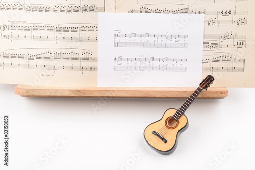 SMALL ACOUSTIC GUITAR WITH MUSIC SCORE