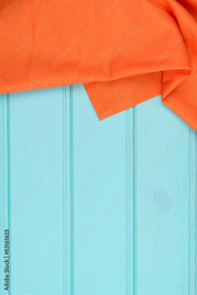 Orange towel over wooden table Orange towel over wooden table