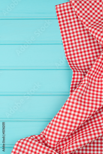 White and red towel over wooden table