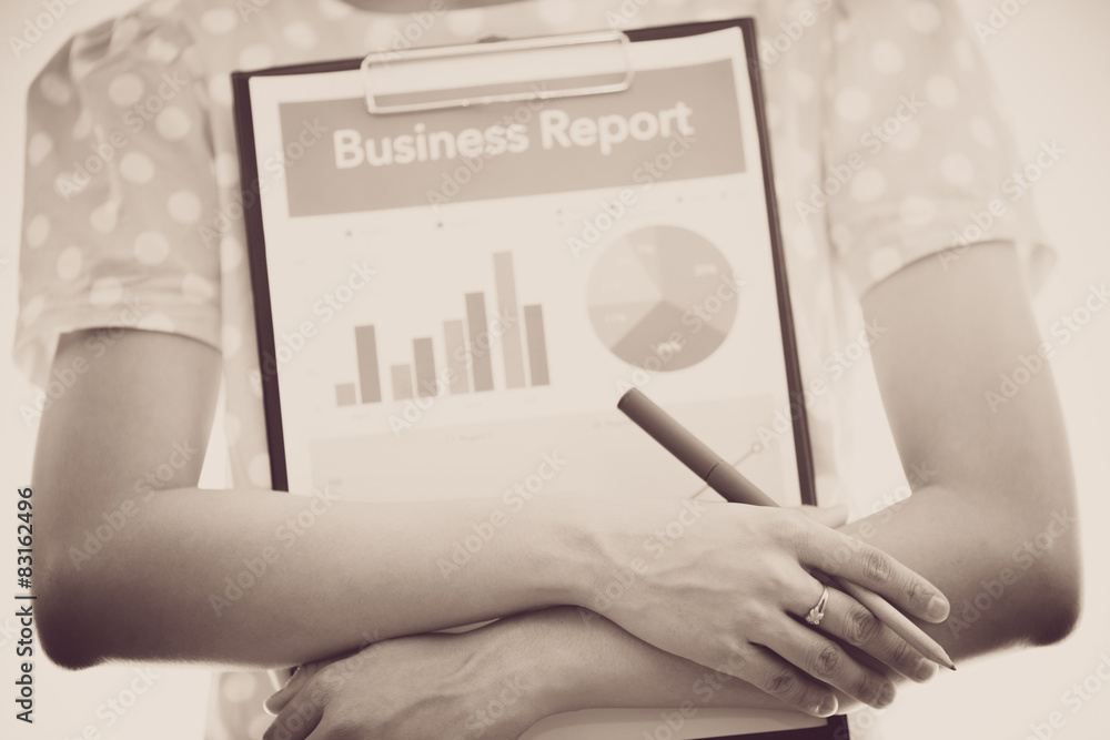woman hand with pen and business report