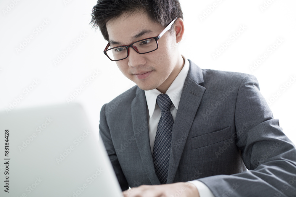 Handsome businessman working with laptop