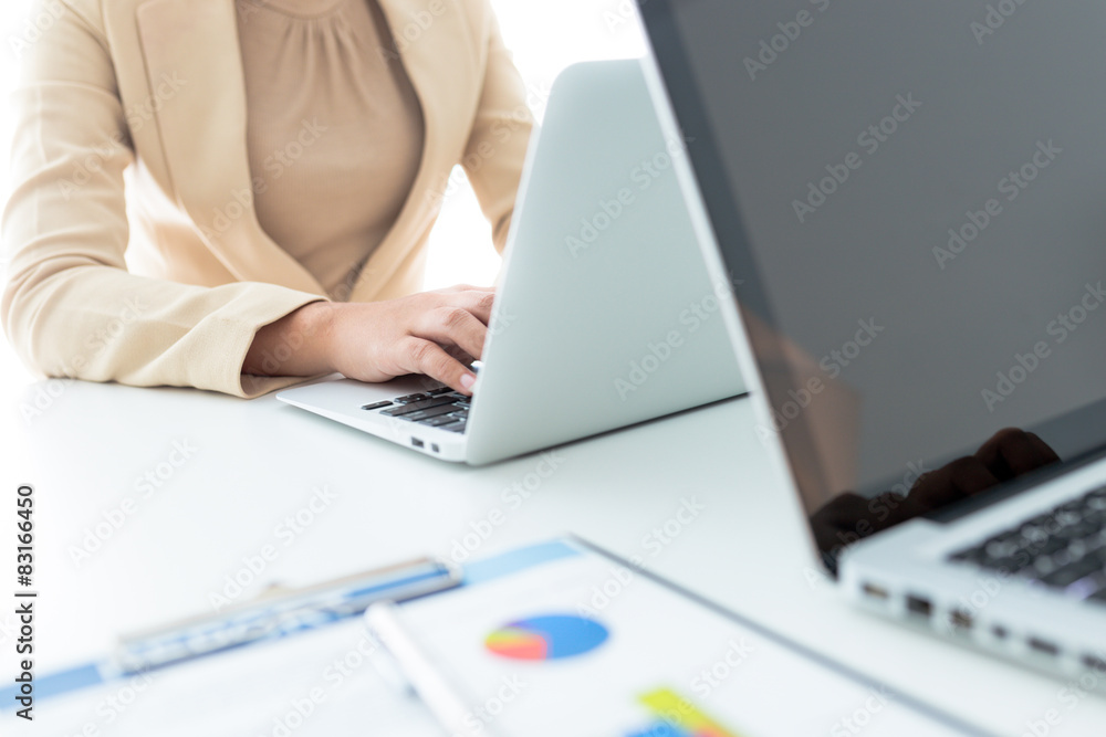 Unrecognizable business person analyzing graphs and taking notes Unrecognizable business person analyzing graphs and taking notes