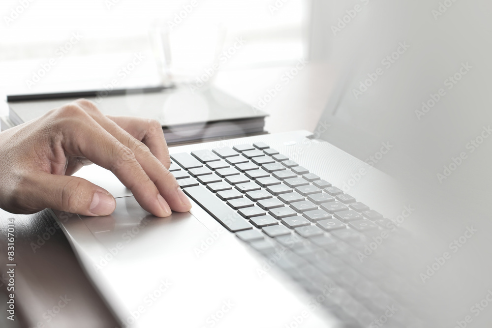 Businessman hand using laptop and mobile phone in office Businessman hand using laptop and mobile phone in office