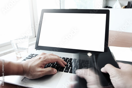 Close up of business man hand working on blank screen laptop com