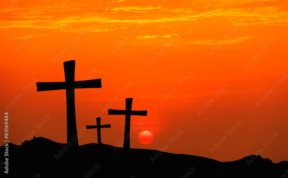 cross silhouette on mountain with sunset sky.