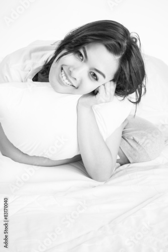 Portrait of a beautiful young woman in bed