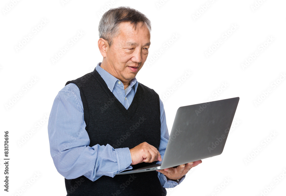 Asian old man use of laptop computer Asian old man use of laptop computer